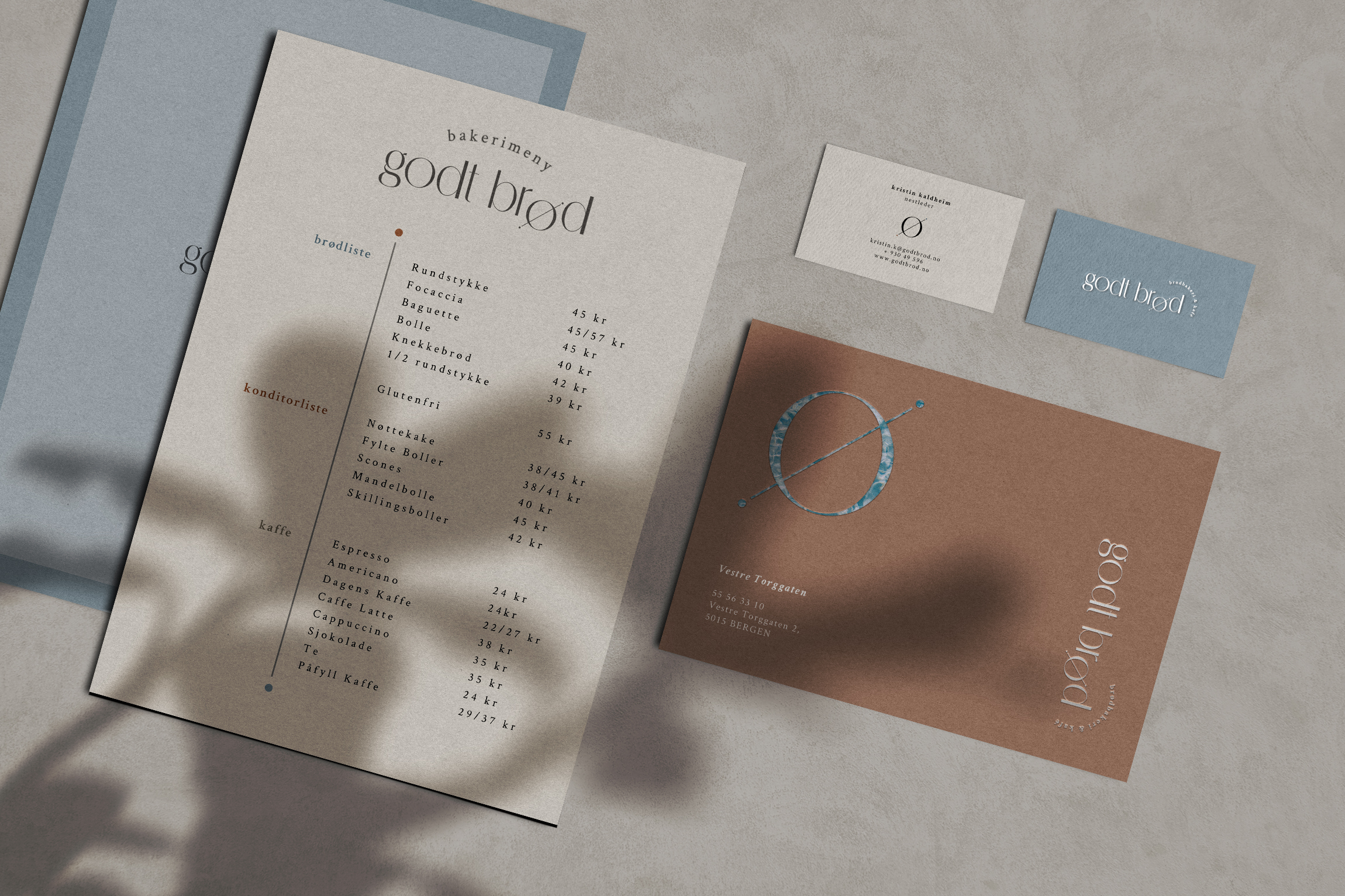 Overhead shot of the bakery cafe menu, two business cards and postcard