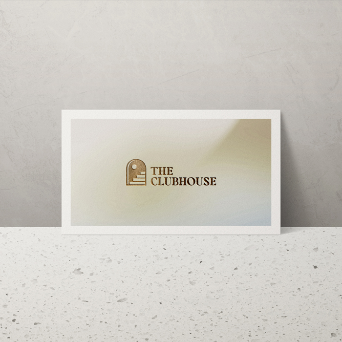 The Clubhouse Business Card on a marbletop table